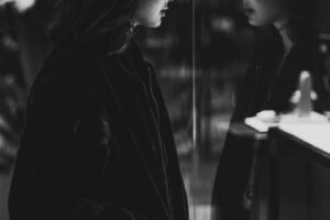 What I Wish I Was vs. What I Am Unlocking Inner Beauty: Embrace Your Unique Self for Confidence and Happiness Black and white photo of girl staring at herself in a window reflecting glass W