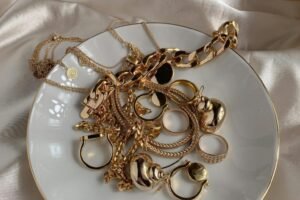 gold necklaces and rings in a white plate