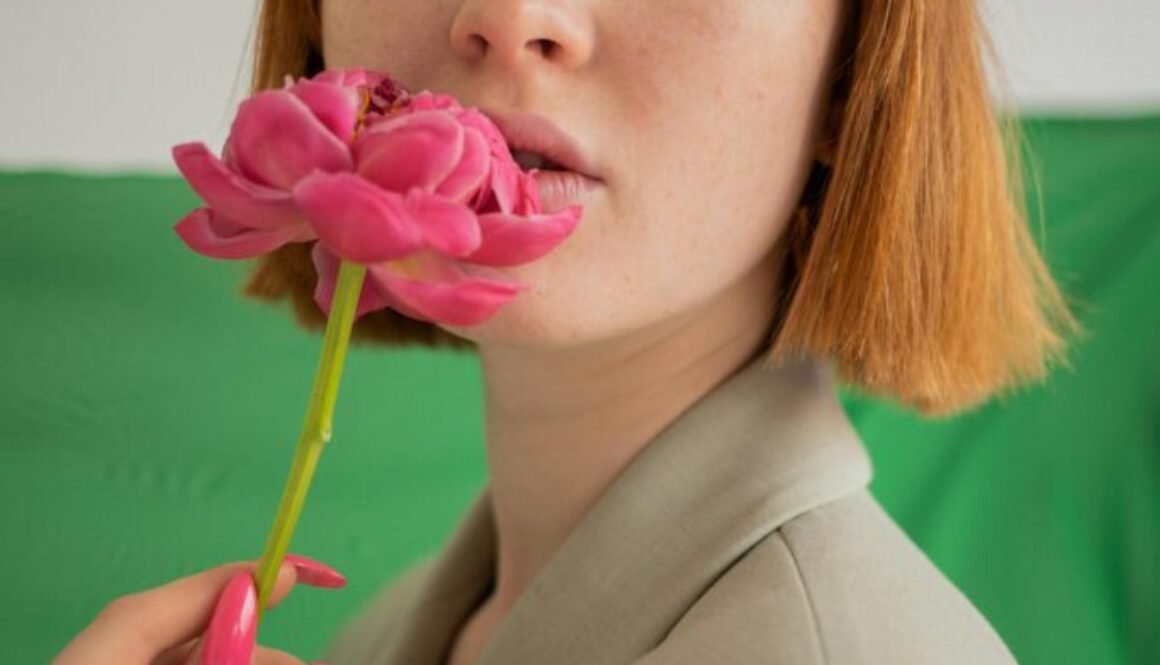 Woman green eyeshadow holding a picture. Lip Stains and how they are good for lips.