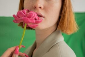 Woman green eyeshadow holding a picture. Lip Stains and how they are good for lips.