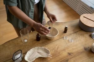 Person making lip balm DIY with essential oils