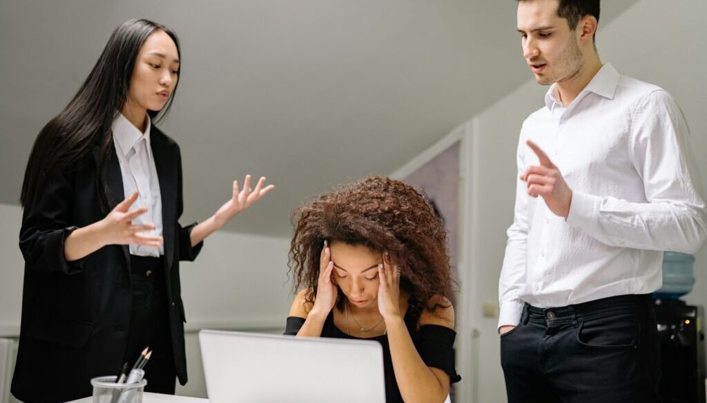 People sitting at a desk stressed