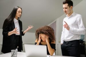 People sitting at a desk stressed