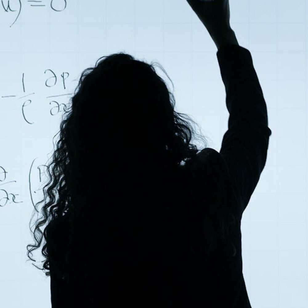 Teacher writing on a whiteboard