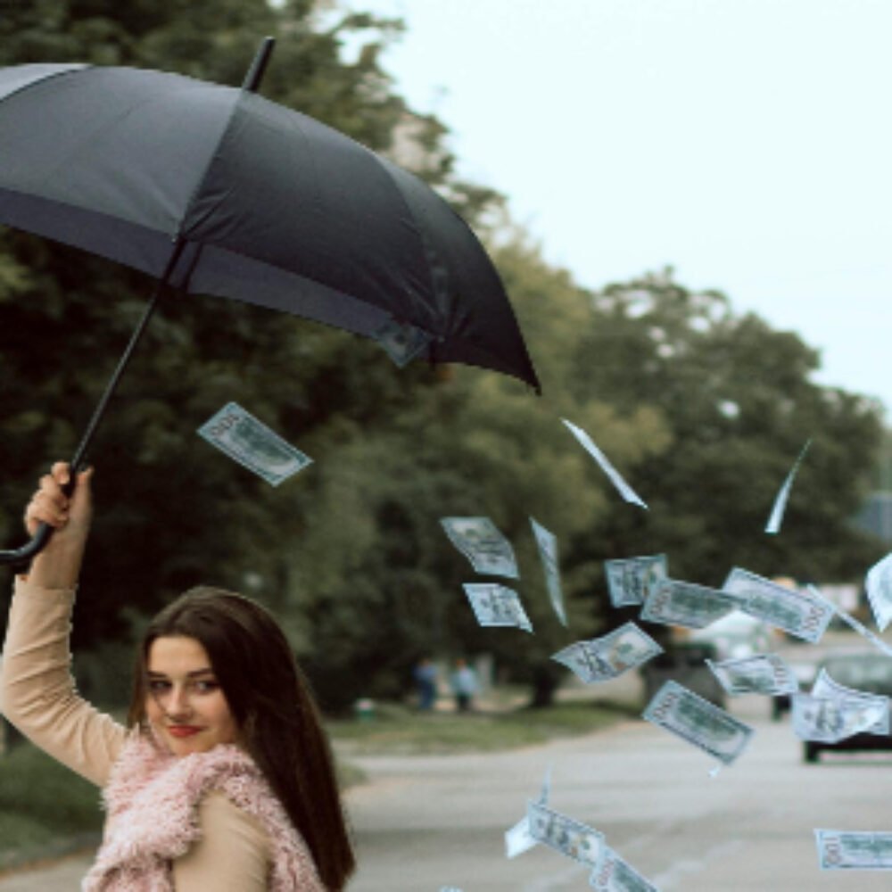 Money falling out of umbrella