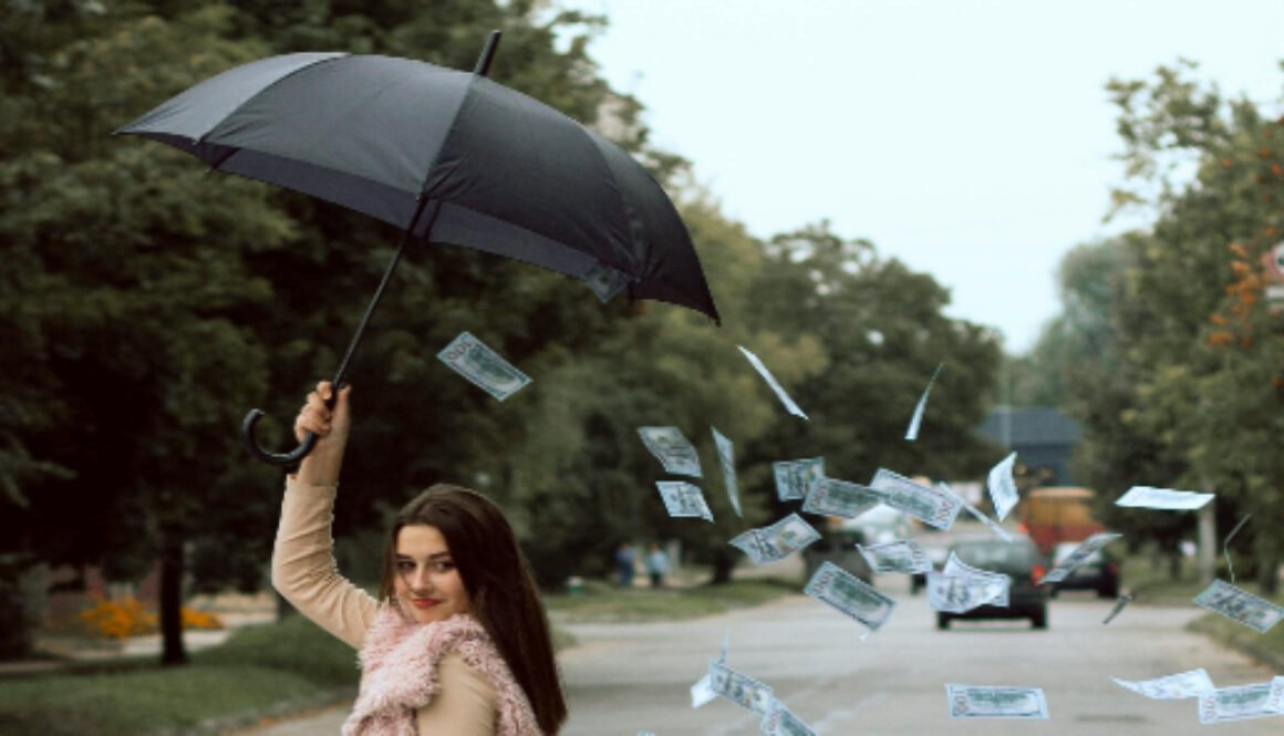 Money falling out of umbrella